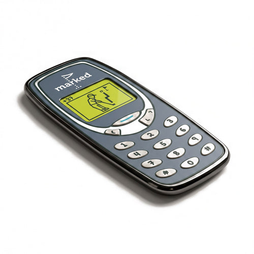 The Brick golf ball marker, a grey mobile phone with a raised keypad and a golfer on the screen, photographed at an angle.