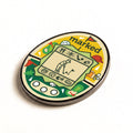 The Golfer golf ball marker, an egg shaped handheld game with a golfer mid swing on the screen and marked above it, photographed at an angle.