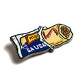 The Sausage Roll golf ball marker, a navy wrapper with a pastry roll emerging, sauce across it and beans at the open end, photographed at an angle.